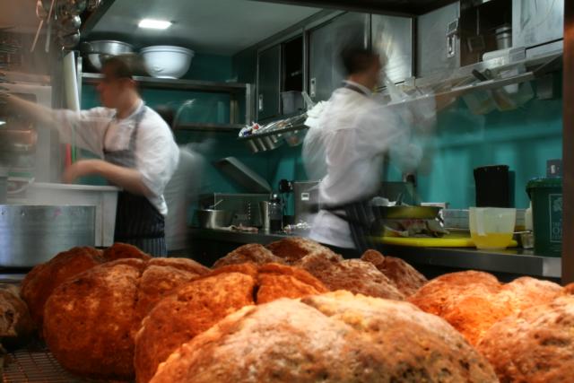 chefs in kitchen environment with Foster Refrigerator equipment and bread