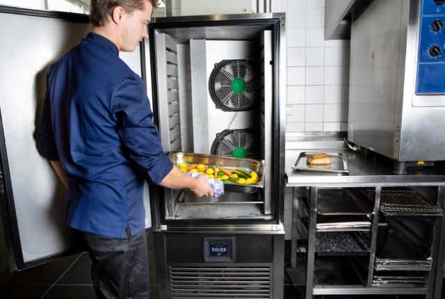 chefs in kitchen environment with Foster Refrigerator equipment and bread