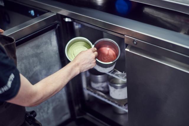 sauces are placed in a refrigerated counter