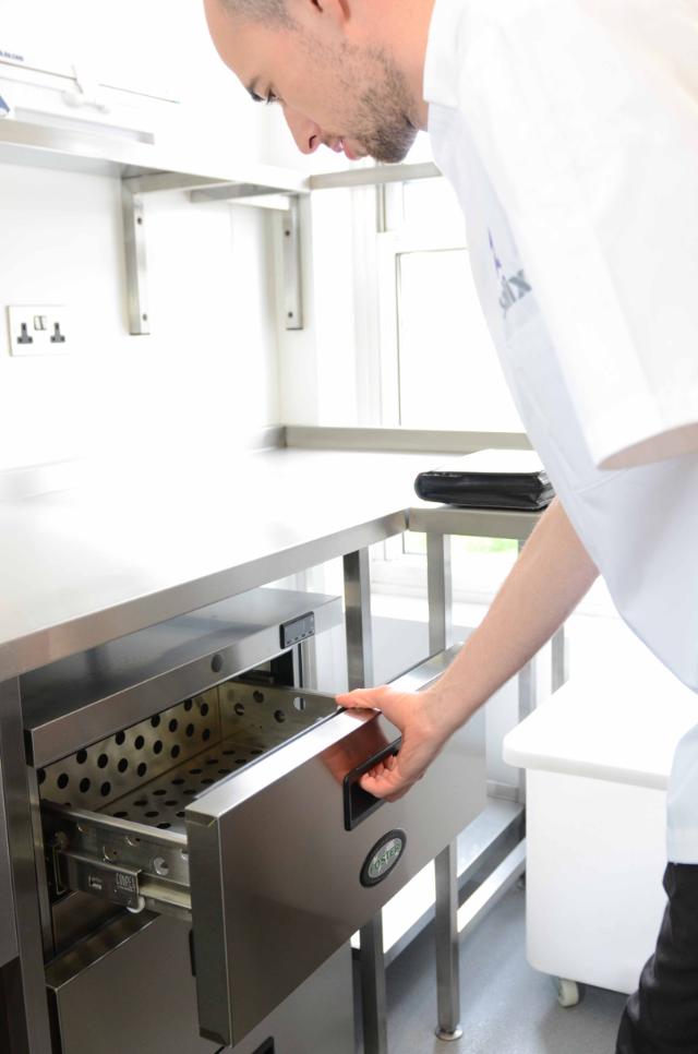 chef opening drawer of Foster Refrigerator equipment