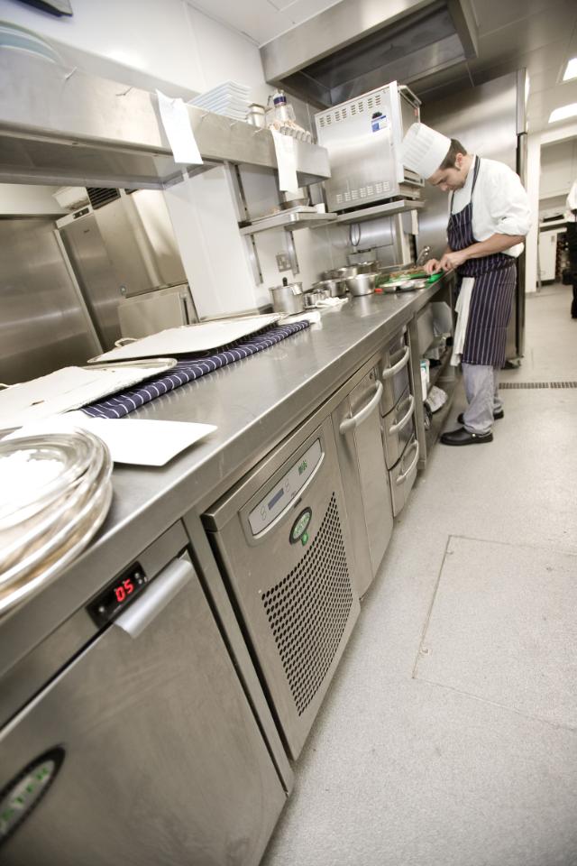 chefs in kitchen environment with Foster counter fridge