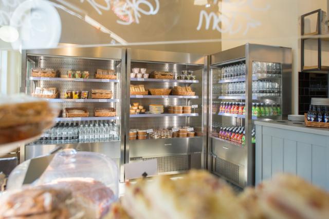 Multideck cabinets loaded with products in a beautiful cafe setting