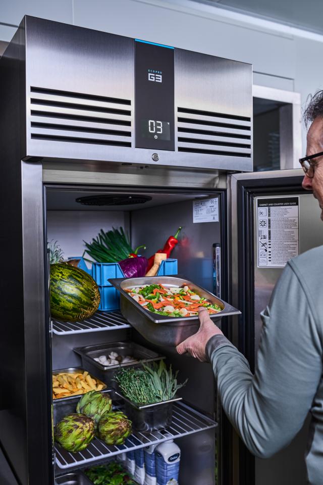 chef storing meet in a Foster counter fridge