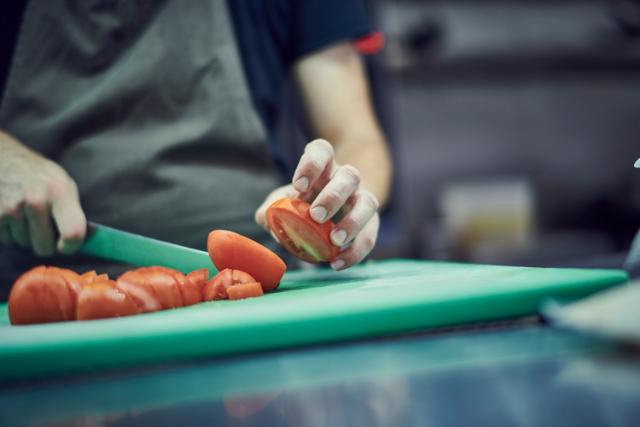 tomatoes are chopped on a board