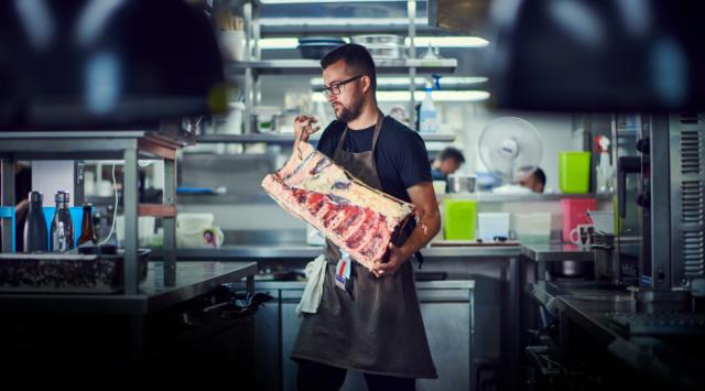 chef carrying loaf of meat