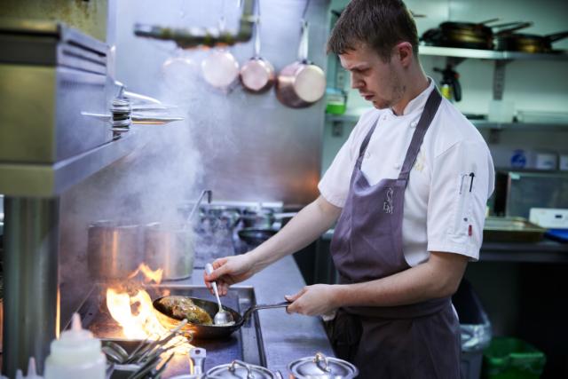 chef cooking in commercial kitchen