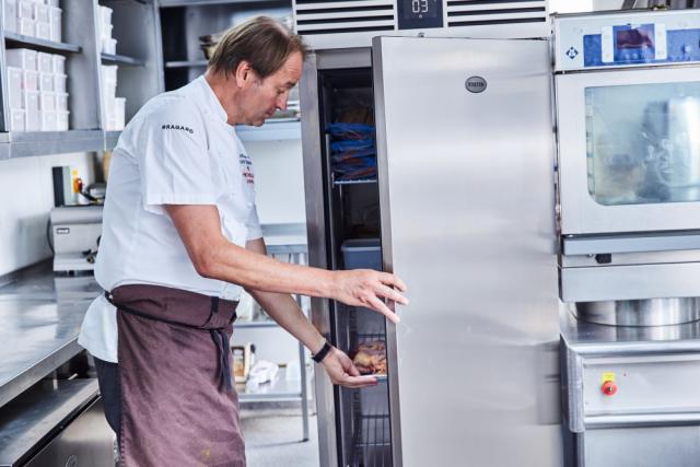 chef next to open cabinet