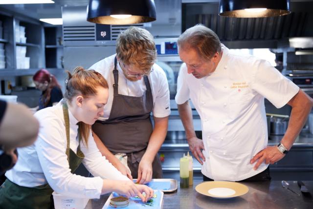 chef and staff preparing meal