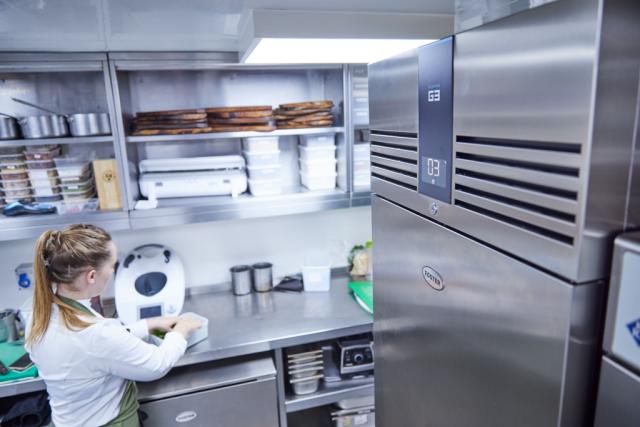 staff preparing food near Foster equipment