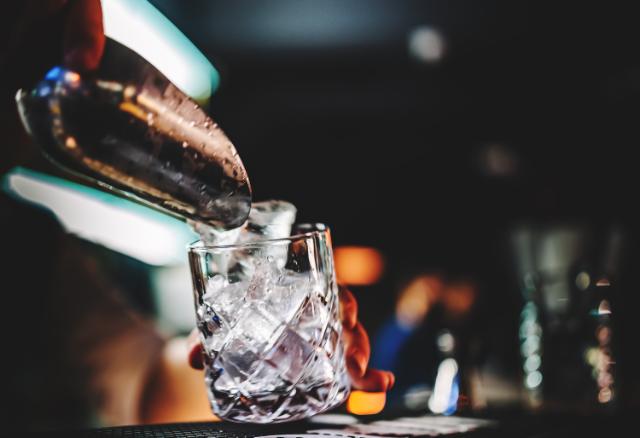 ice is poured into a glass tumbler