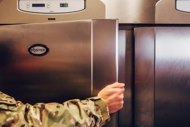 Foster fridge door being opened by military chef